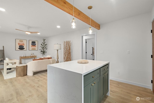 kitchen with a kitchen island, pendant lighting, beamed ceiling, ceiling fan, and light hardwood / wood-style floors