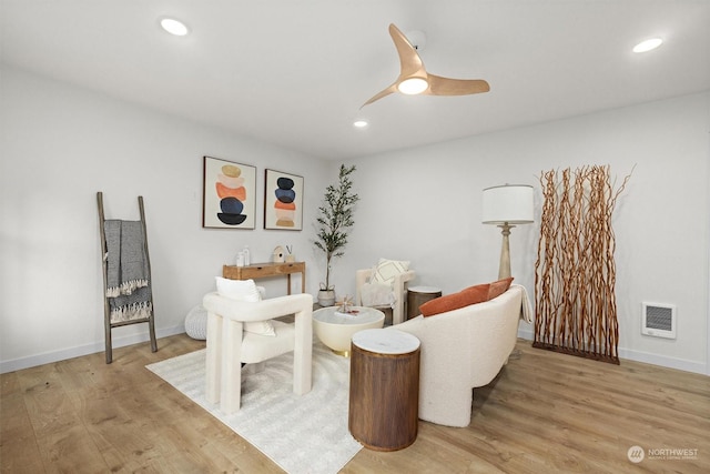 sitting room featuring ceiling fan and light wood-type flooring