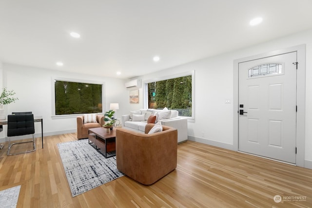 living room with hardwood / wood-style flooring and a wall mounted air conditioner