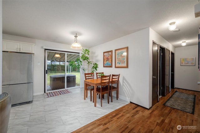 dining area with a textured ceiling