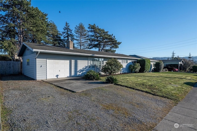 ranch-style house with a garage and a front yard