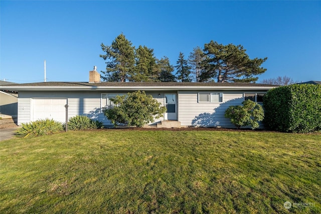 single story home featuring a garage and a front lawn