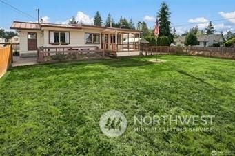 rear view of house with a yard