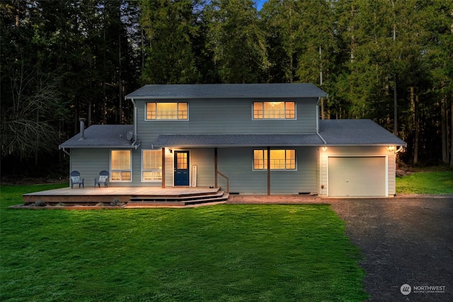 view of front of home with a garage and a front yard