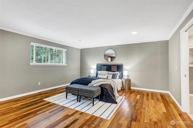 bedroom featuring crown molding and light wood-type flooring