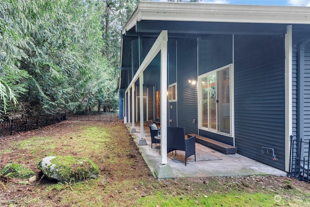 view of yard featuring a patio and a sunroom