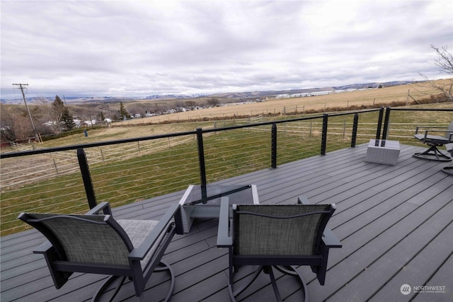 wooden deck with a rural view