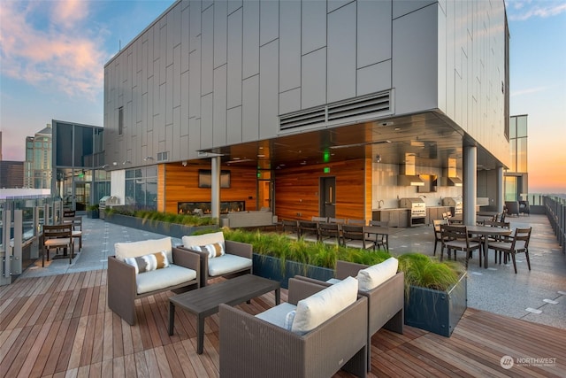 deck at dusk with an outdoor living space