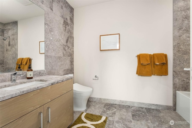 bathroom with vanity, a shower, and toilet