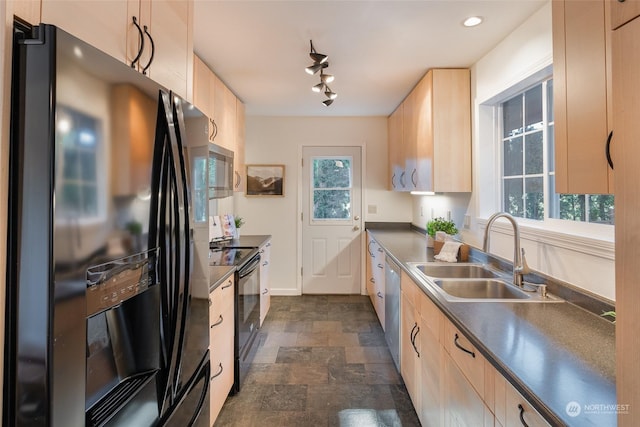 kitchen featuring a wealth of natural light, sink, light brown cabinets, and black appliances