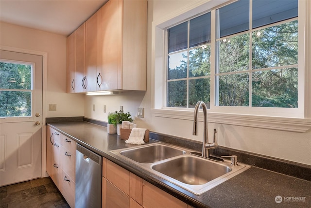 kitchen with light brown cabinetry, sink, and dishwasher