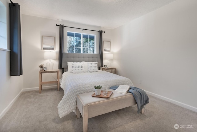 carpeted bedroom featuring a textured ceiling