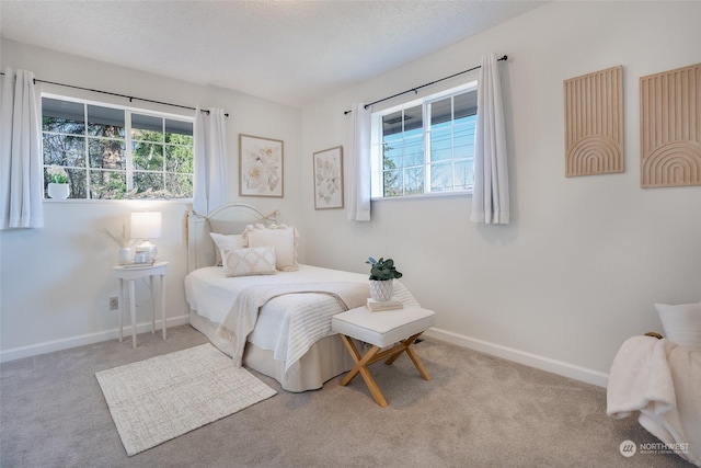 carpeted bedroom featuring a textured ceiling