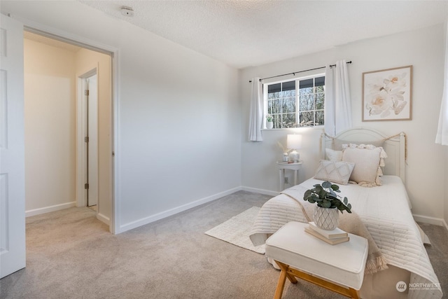 carpeted bedroom featuring a textured ceiling