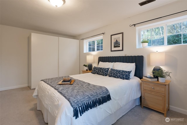 bedroom featuring light colored carpet