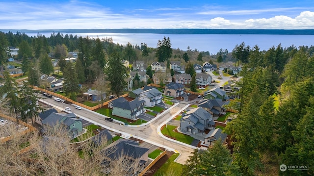 drone / aerial view featuring a residential view and a water view