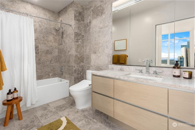 full bathroom featuring vanity, tile walls, shower / tub combo, and toilet