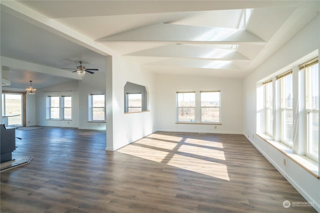 interior space featuring vaulted ceiling, a healthy amount of sunlight, ceiling fan with notable chandelier, and dark hardwood / wood-style floors