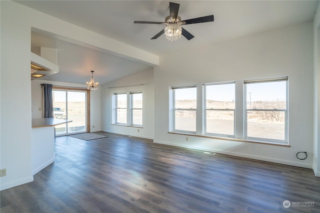 unfurnished living room featuring ceiling fan with notable chandelier, vaulted ceiling, and dark hardwood / wood-style floors