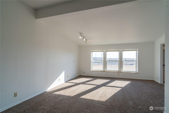 carpeted spare room with lofted ceiling with beams and rail lighting