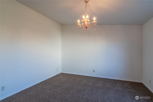 spare room with an inviting chandelier and carpet floors