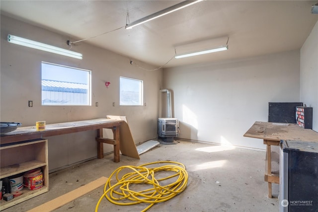 basement featuring a wood stove and a workshop area