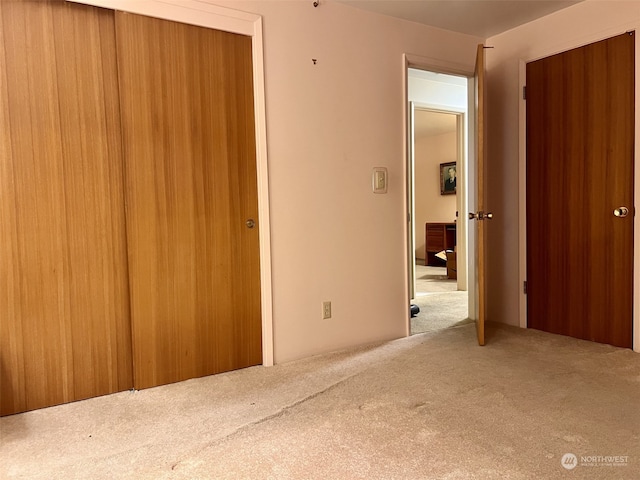 unfurnished bedroom with carpet and a closet