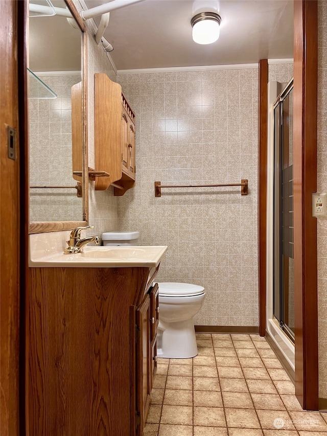 bathroom featuring an enclosed shower, ornamental molding, vanity, and toilet