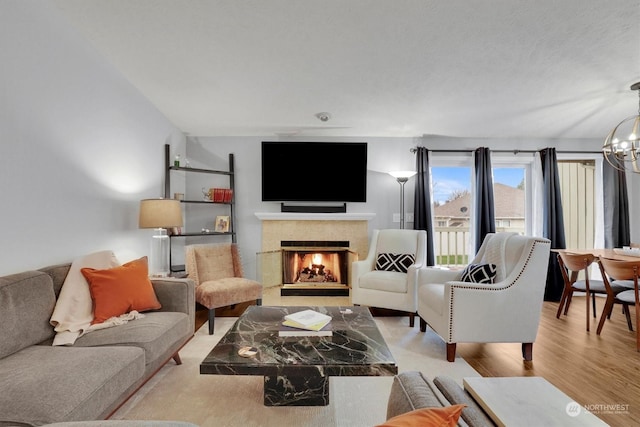 living room with a chandelier and light hardwood / wood-style flooring