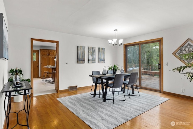 dining room featuring a chandelier and light hardwood / wood-style flooring