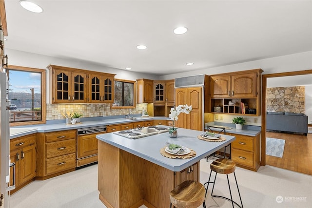 kitchen with tasteful backsplash, an island with sink, paneled appliances, and a kitchen breakfast bar