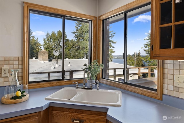 interior space with sink and backsplash