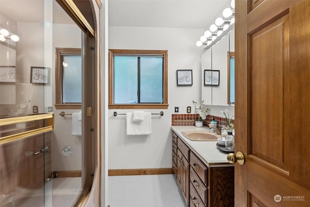 bathroom with vanity and a shower with door