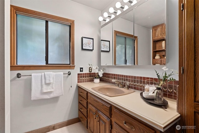 bathroom featuring vanity and backsplash