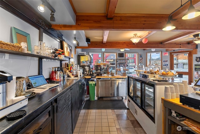 bar featuring beamed ceiling, dark tile patterned floors, beverage cooler, and ceiling fan