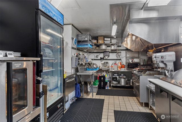 kitchen with fridge and light tile patterned floors