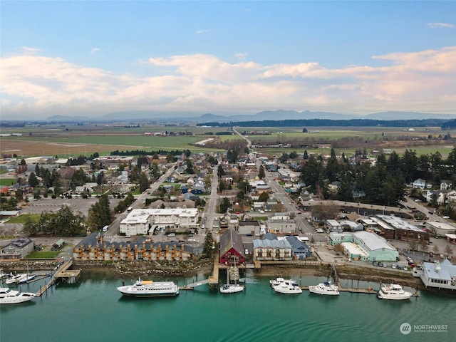 drone / aerial view with a water and mountain view