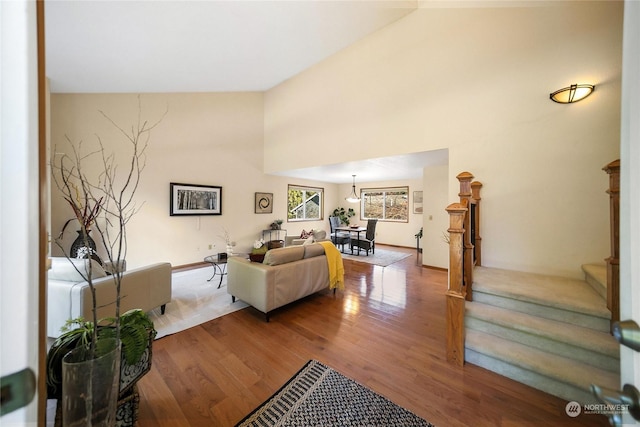 living room featuring stairway, a high ceiling, and wood finished floors