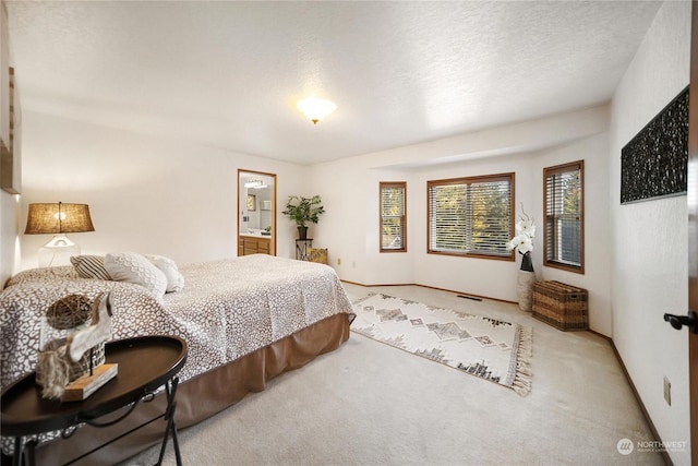 bedroom with a textured ceiling and carpet