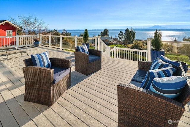 wooden terrace featuring a water and mountain view