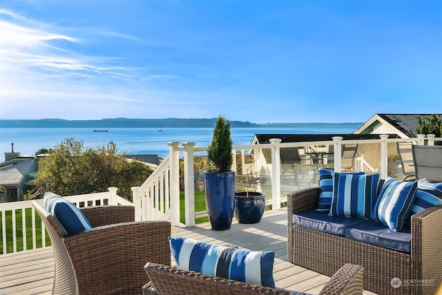 wooden deck featuring an outdoor hangout area and a water view