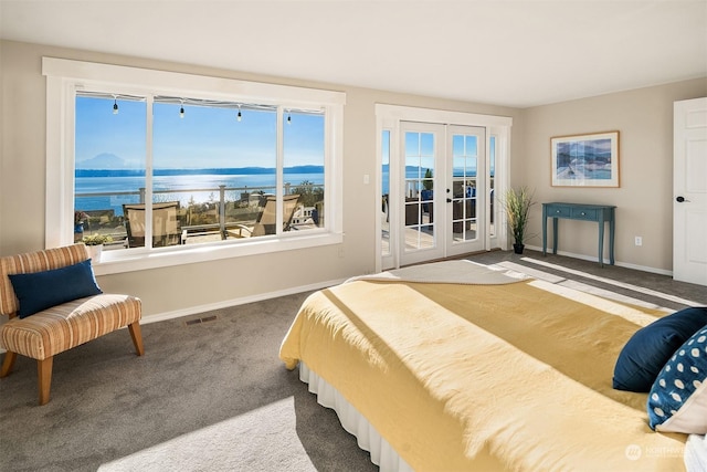 carpeted bedroom featuring baseboards, visible vents, a water view, access to exterior, and french doors