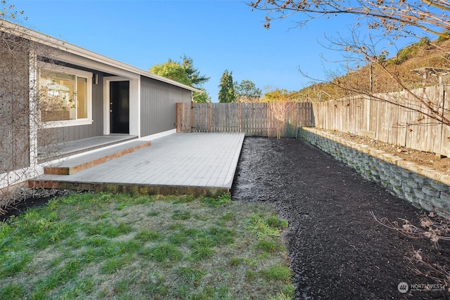 view of yard featuring a fenced backyard and a wooden deck