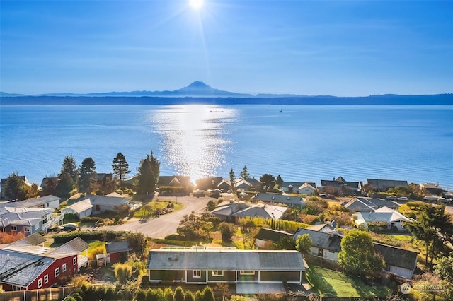 drone / aerial view with a residential view and a water and mountain view