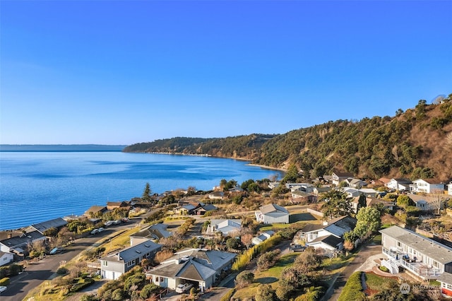 drone / aerial view featuring a water view and a residential view