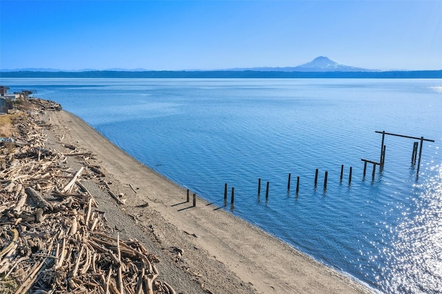 property view of water with a boat dock and a mountain view