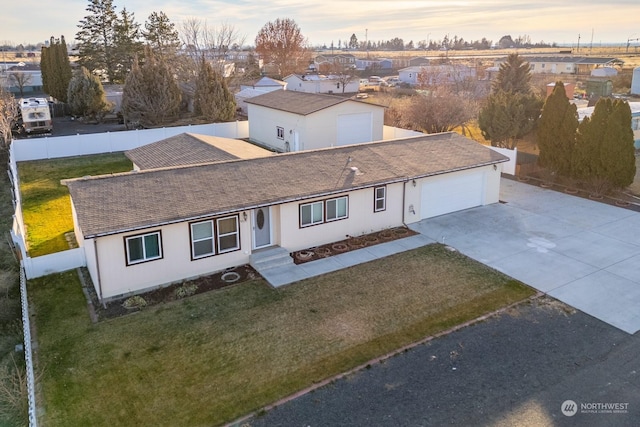 view of front facade featuring a garage and a yard