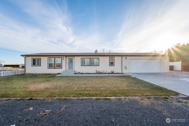 single story home featuring a garage and a front lawn