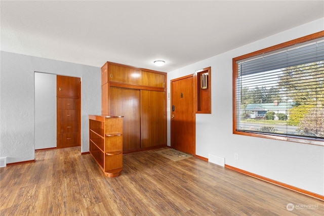 unfurnished bedroom featuring dark hardwood / wood-style flooring