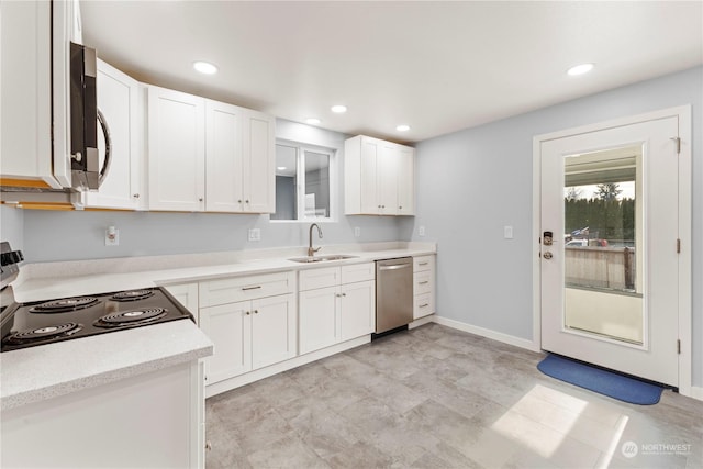 kitchen featuring stainless steel appliances, white cabinetry, and sink